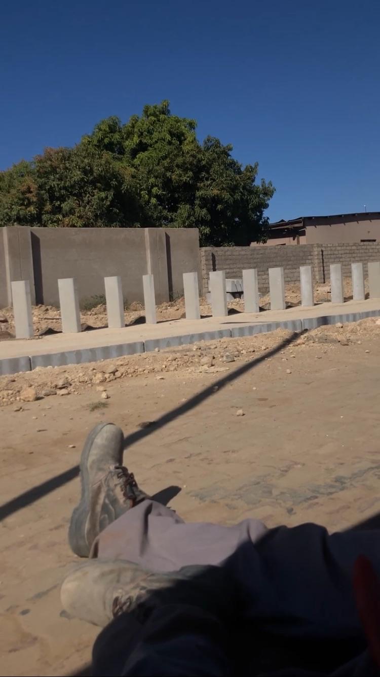 Boundary wall columns and surrounding groundworks during construction.